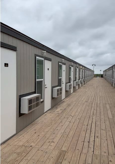 Covered walkway along a row of modular workforce housing units